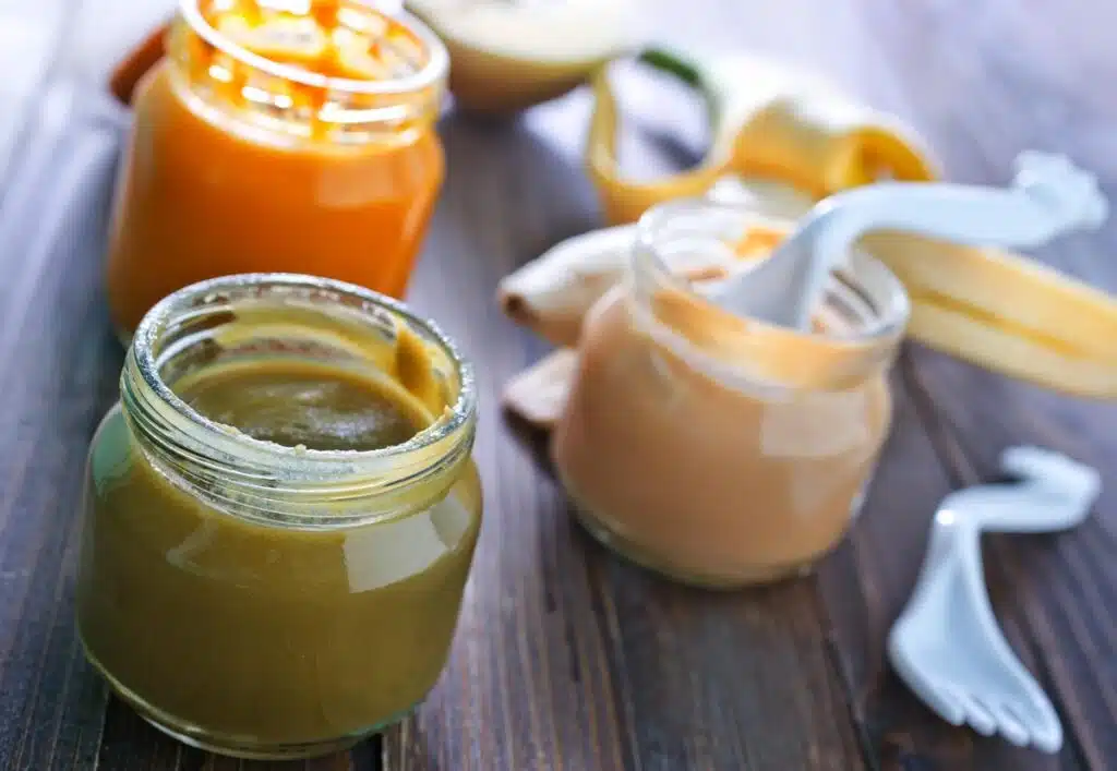 Close up of three baby food jars.