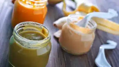 Close up of three baby food jars.