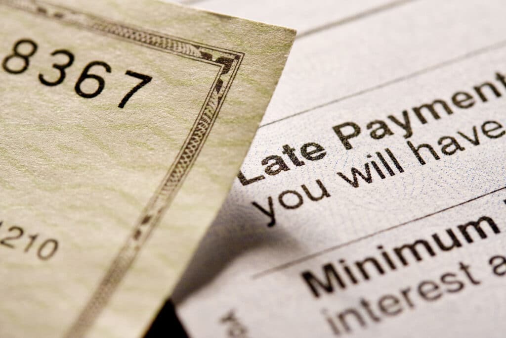 Close up of a document that displays late payment information, representing the GHP Management class action lawsuit settlement.