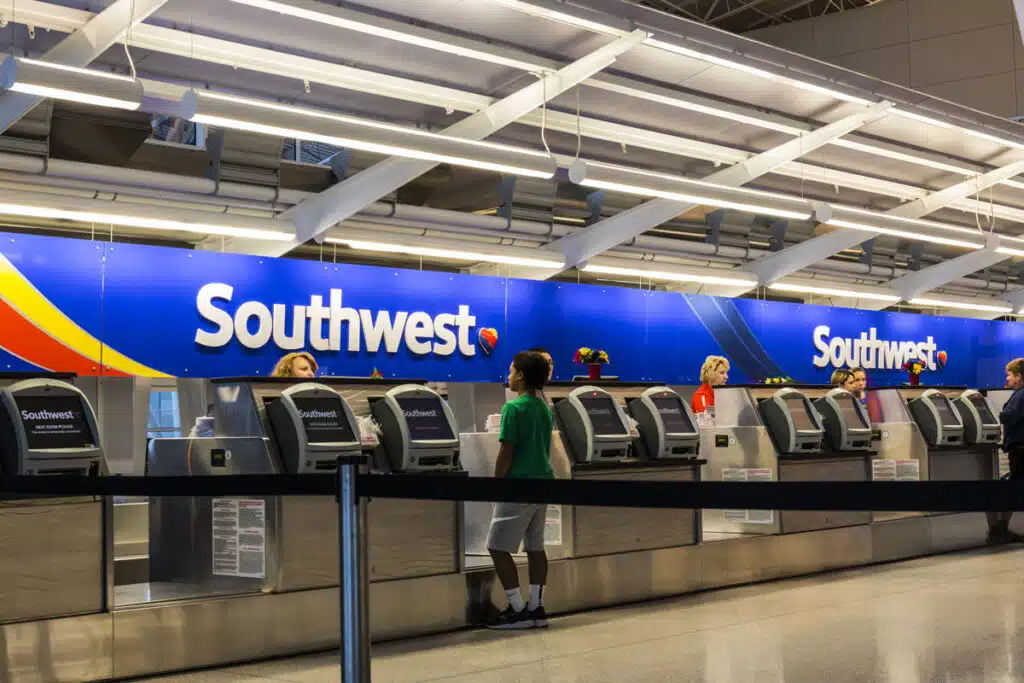 Southwest Airlines check-in desk preparing passengers for departure - class action