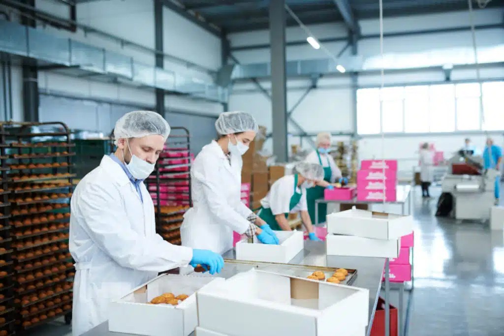 Factory Food Employees working, representing the Lyons Magnus recall and FDA warning.