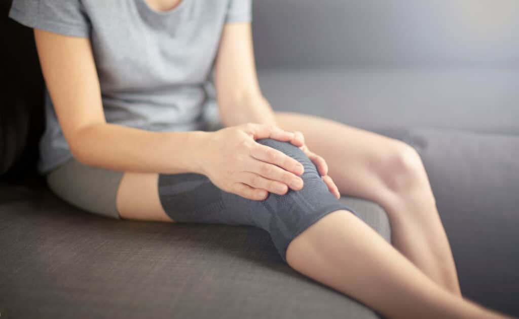 Person in pain with knee brace