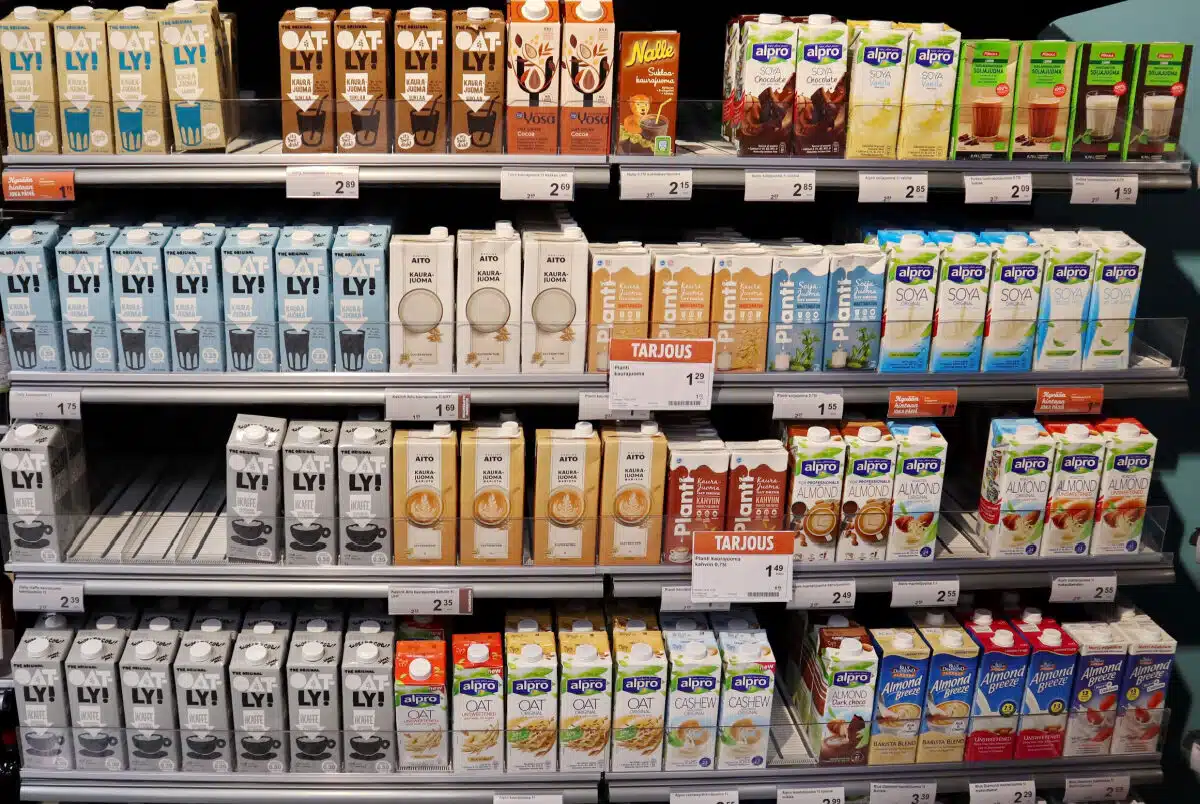 Plant-based milk cartons on grocery store shelf, representing the FDA milk proposal.