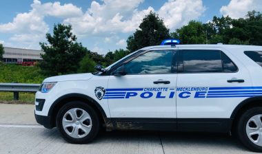 Charlotte Mecklenburg Police car on the side of highway, representing the Charlotte-Mecklenburg Volunteer Police Pledge Fund settlement.