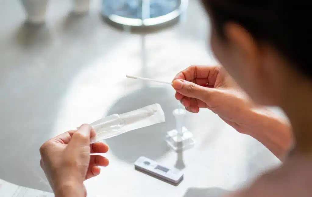 Close up of a womans hands holding a COVID test.
