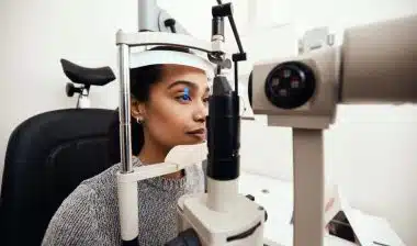 A young girl completing an eye test at a doctors office, representing the 20/20 Eye Care Network and Hearing Care Network data breach settlement.