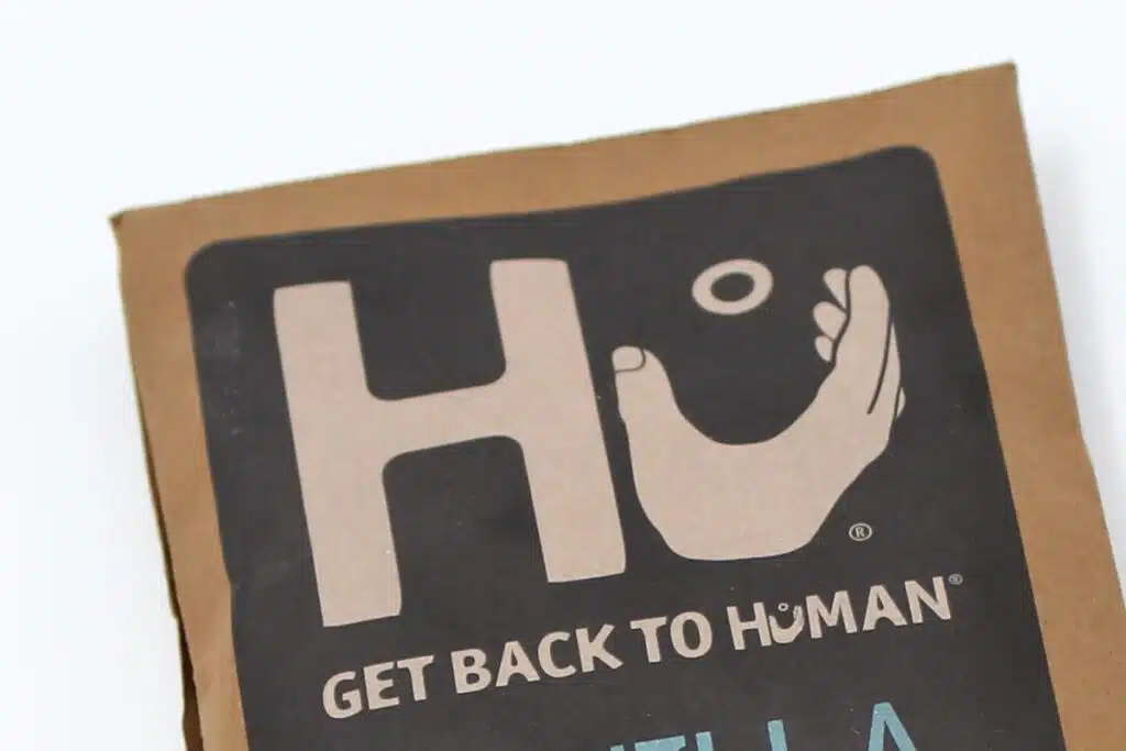 Close up of Hu brand logo on a chocolate bar wrapper.