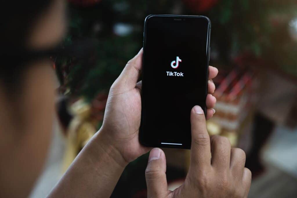 Closed up image of a Male using Tiktok application on a smartphone - TikTok choking challenge class action