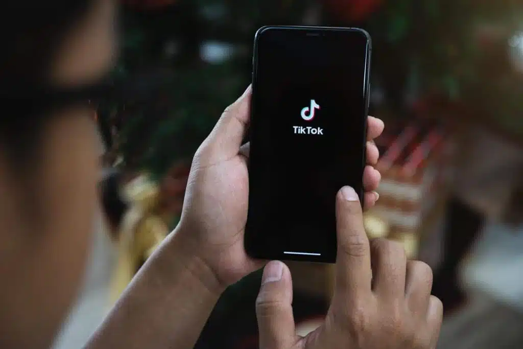 Closed up image of a Male using Tiktok application on a smartphone - TikTok choking challenge class action