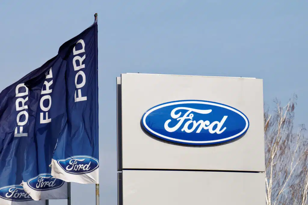 Ford sign and flags near Ford car selling and service center.