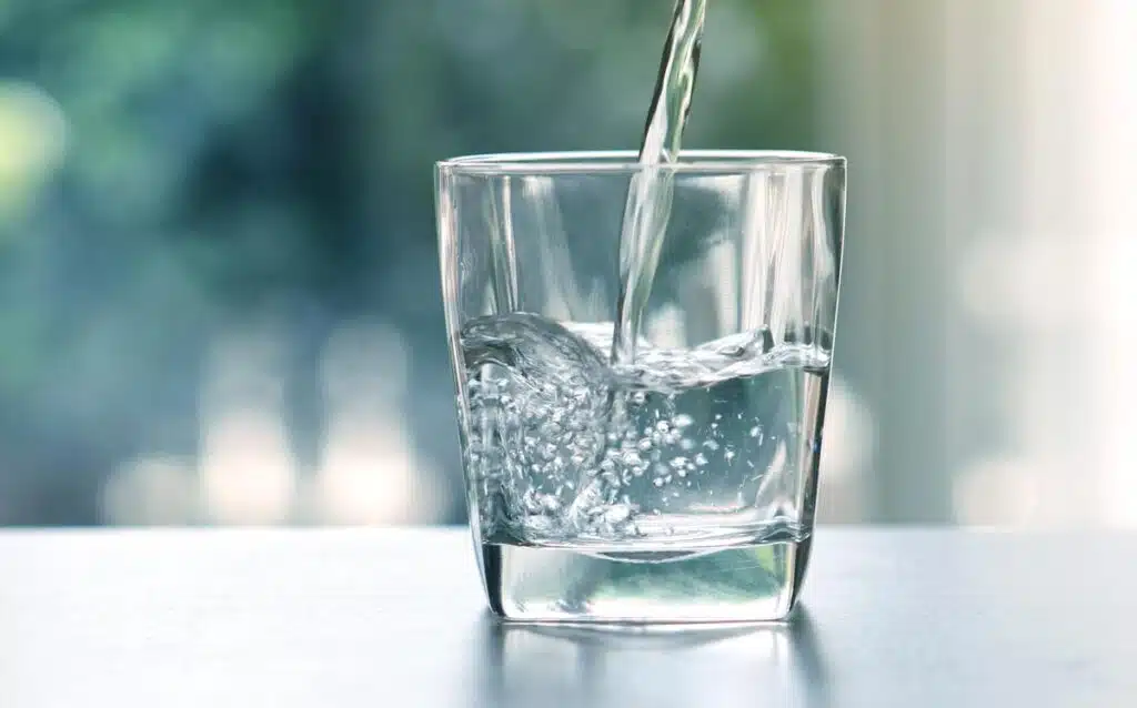 Close up of Water being poured into a glass, representing the Pluris Wedgefield class action settlement.