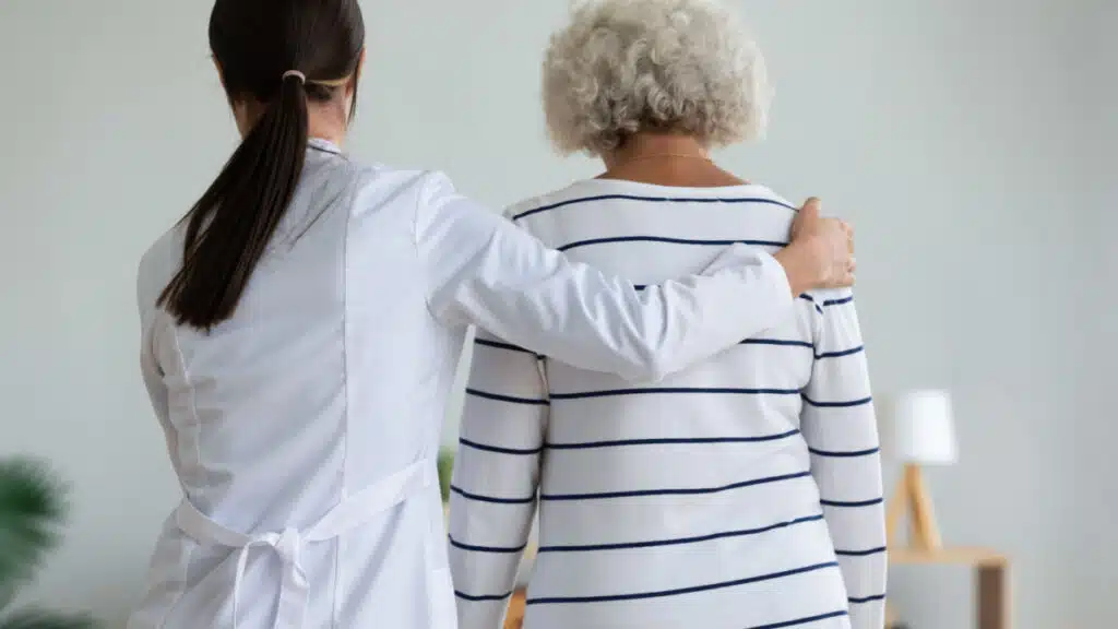 Doctor with arm around patient. Representing the Preferred Home Care and AssistCare data breach class action lawsuit settlement