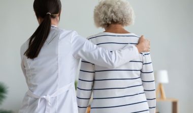 Doctor with arm around patient. Representing the Preferred Home Care lawsuit settlement