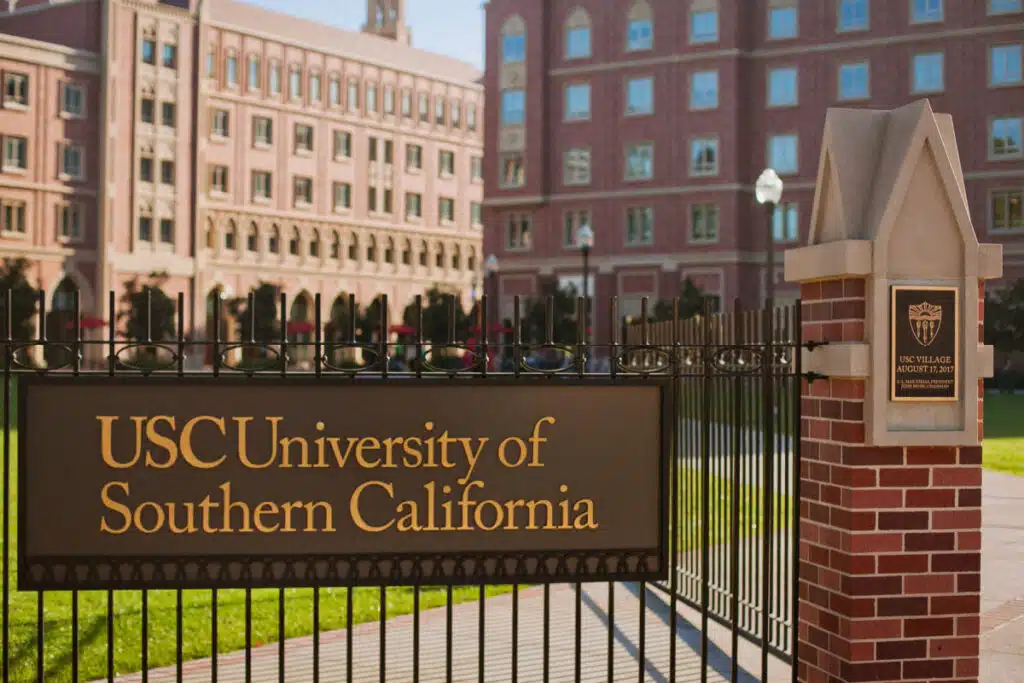 Sign on metal gate that reads "USC University of Southern California," representing the USC retirement plan class action lawsuit
