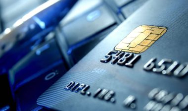 Pen & Bank card on a keyboard, representing the Envision Credit Union data breach settlement.