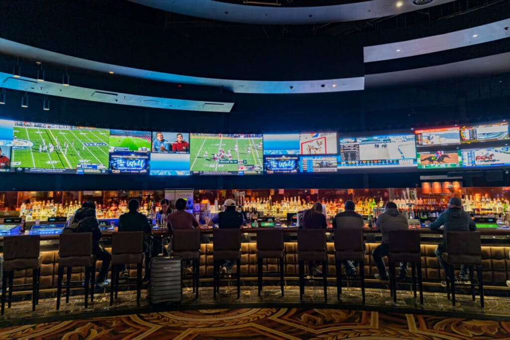 People watching multiple TVs with sports on them