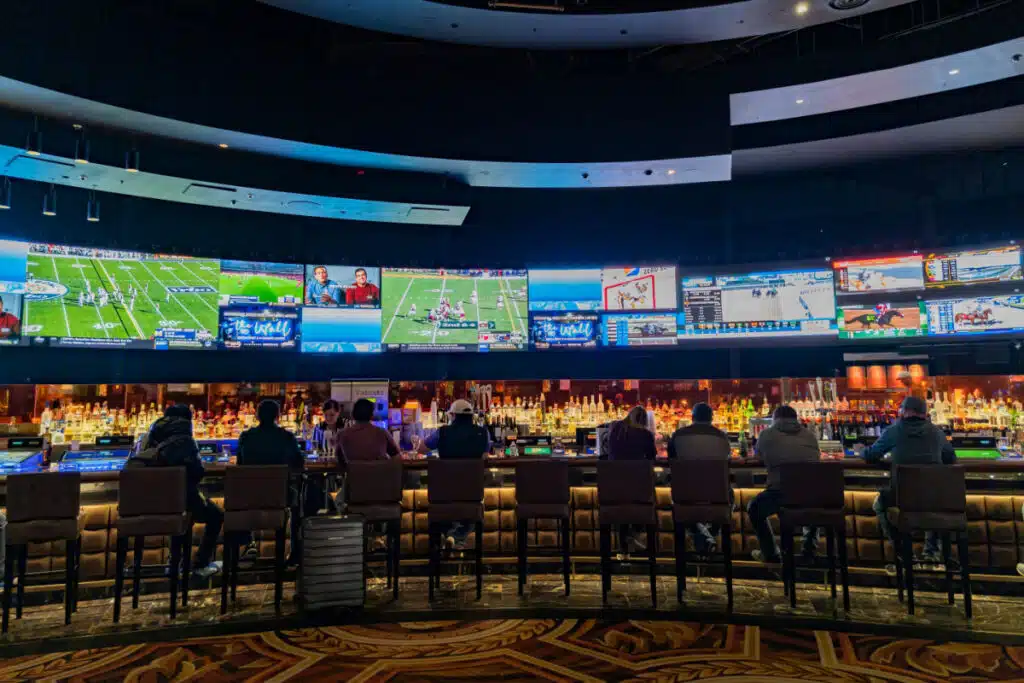 People watching multiple TVs with sports on them