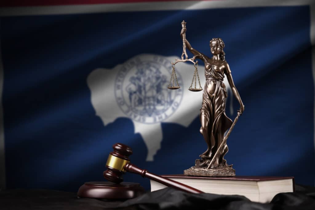 Justice statute with Wyoming state seal behind it