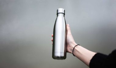 A person holding a metal water bottle