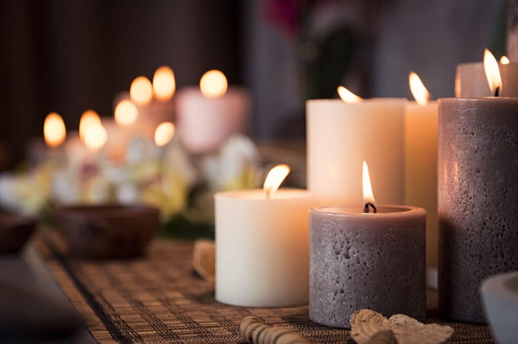 Multiple burning candles in dark room