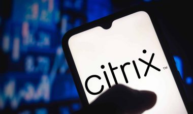 A thumb touches a smartphone that reads "Citrix" on the screen, representing the Citrix TCPA class action lawsuit settlement.