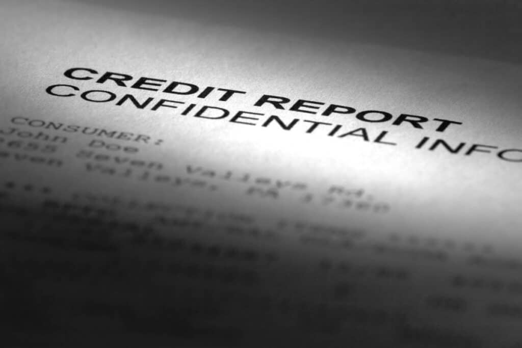 A paper that reads "Credit Report, Confidential",representing the Preferred Precision Group class action lawsuit settlement.