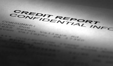 A paper that reads "Credit Report, Confidential",representing the Preferred Precision Group settlement.