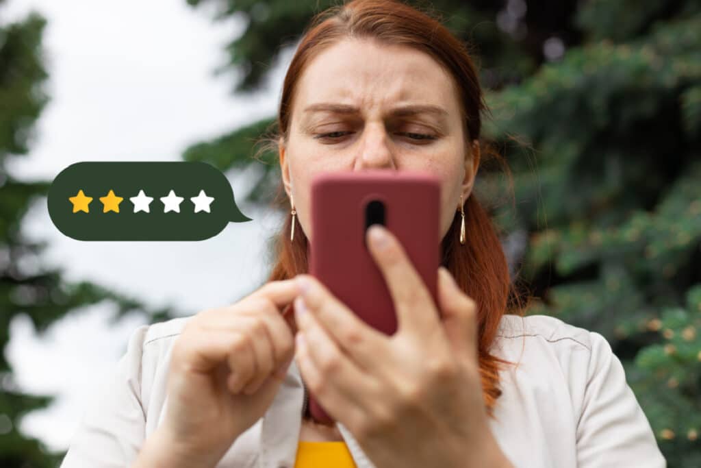 Angry customer giving a 2 star review on cellphone