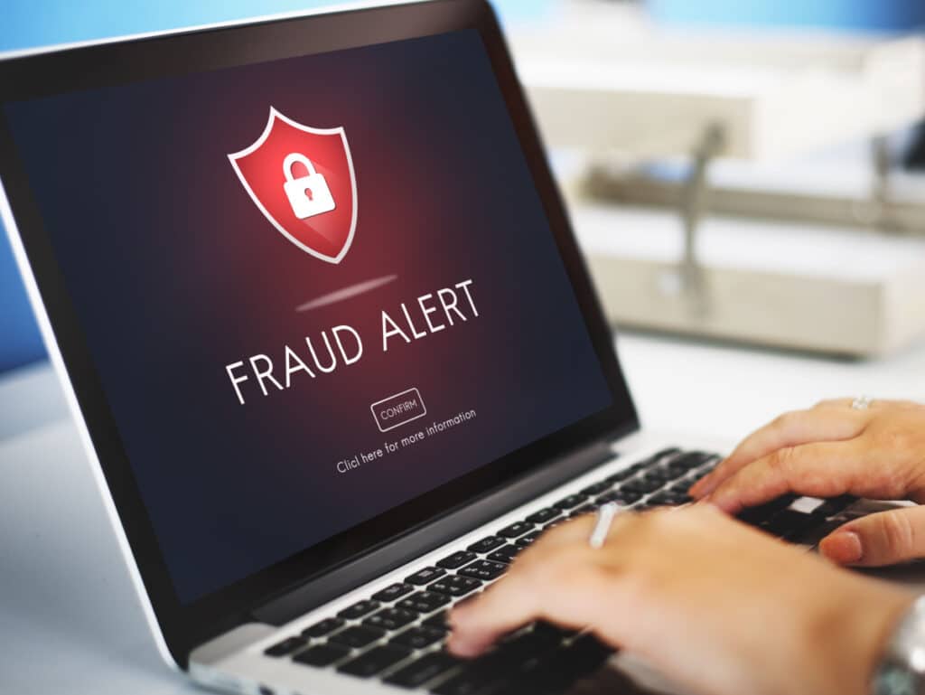 Fraud alert warning on laptop