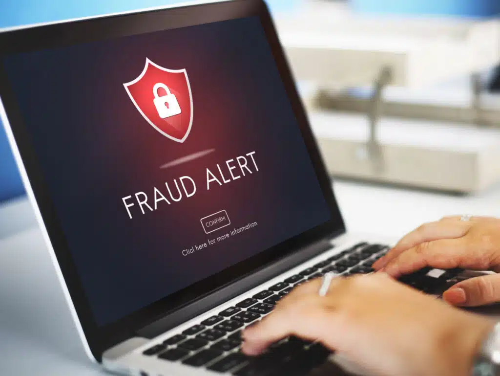 Fraud alert warning on laptop