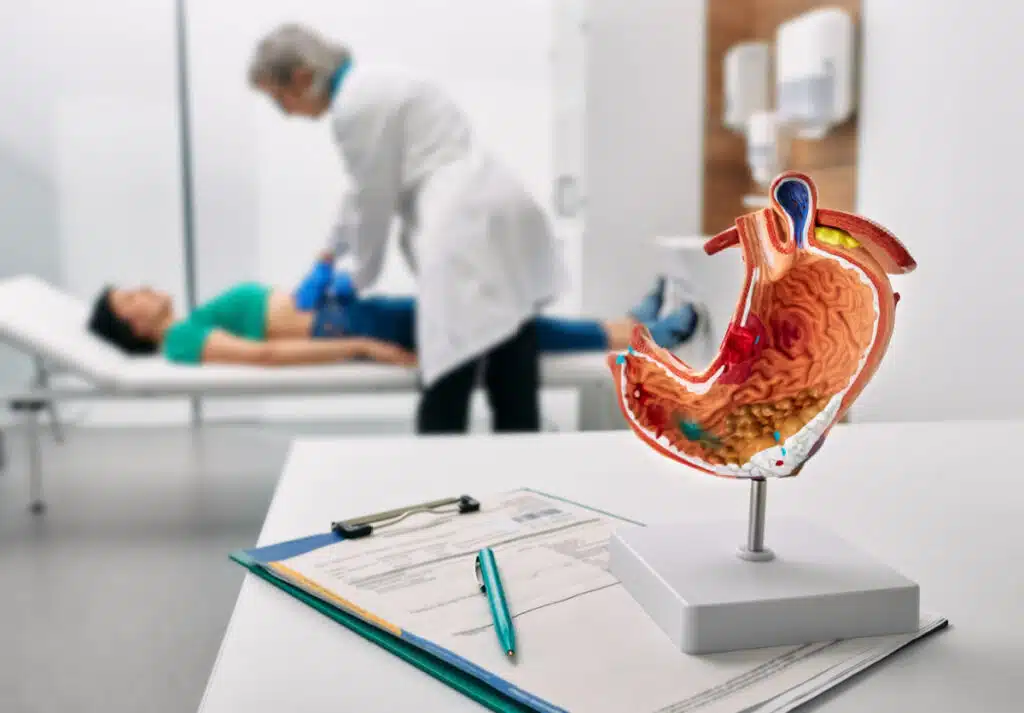 A doctor examining a patient, representing the Illinois Gastroenterology Group class action lawsuit settlement; a claim form is required.