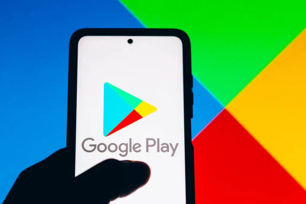 Google play logo on cellphone representing the Google Play app developer class action lawsuit settlement.