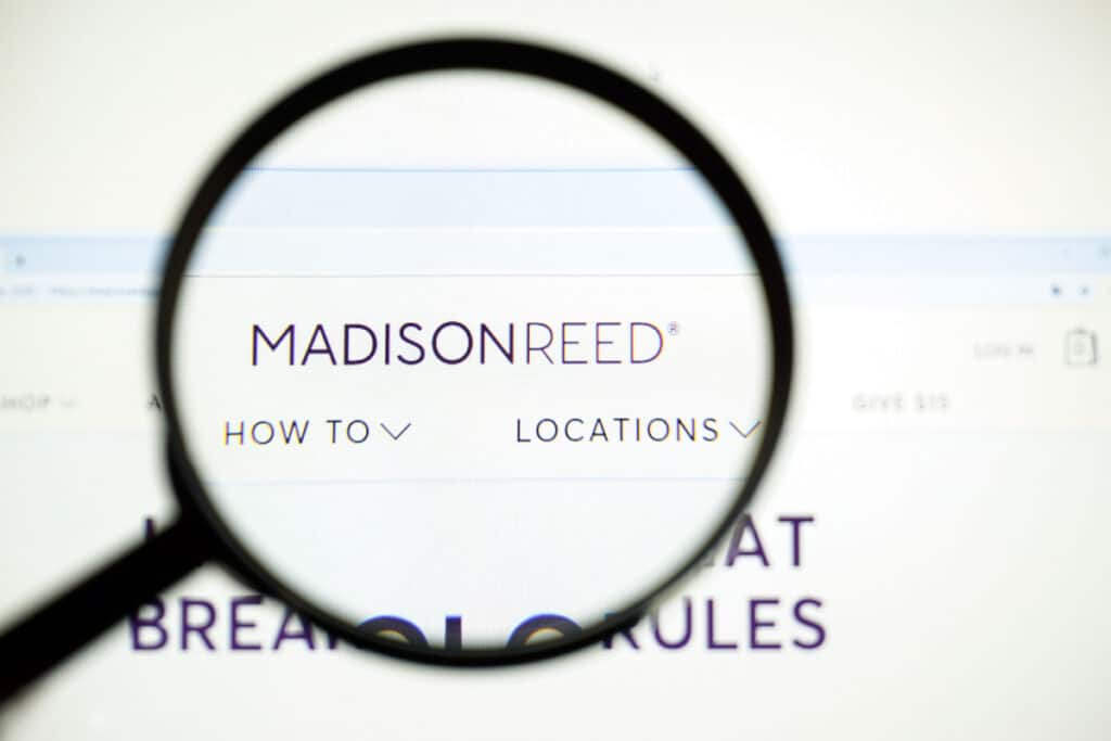 Magnifying glass looking into the Madison Reed website.
