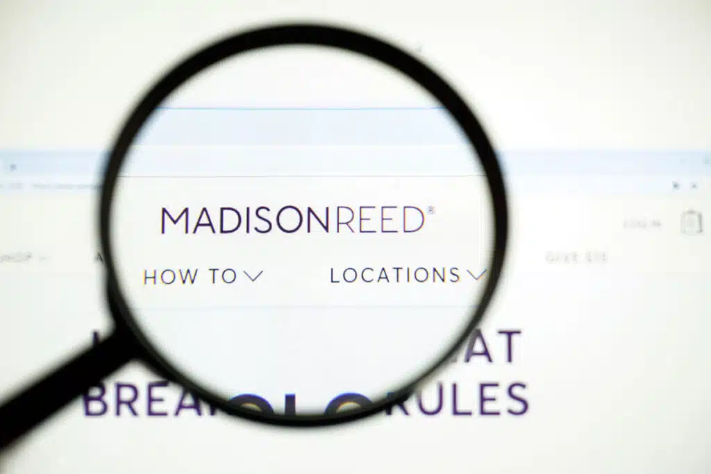 Magnifying glass looking into the Madison Reed website.