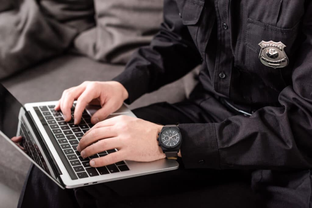 A police officer working on laptop