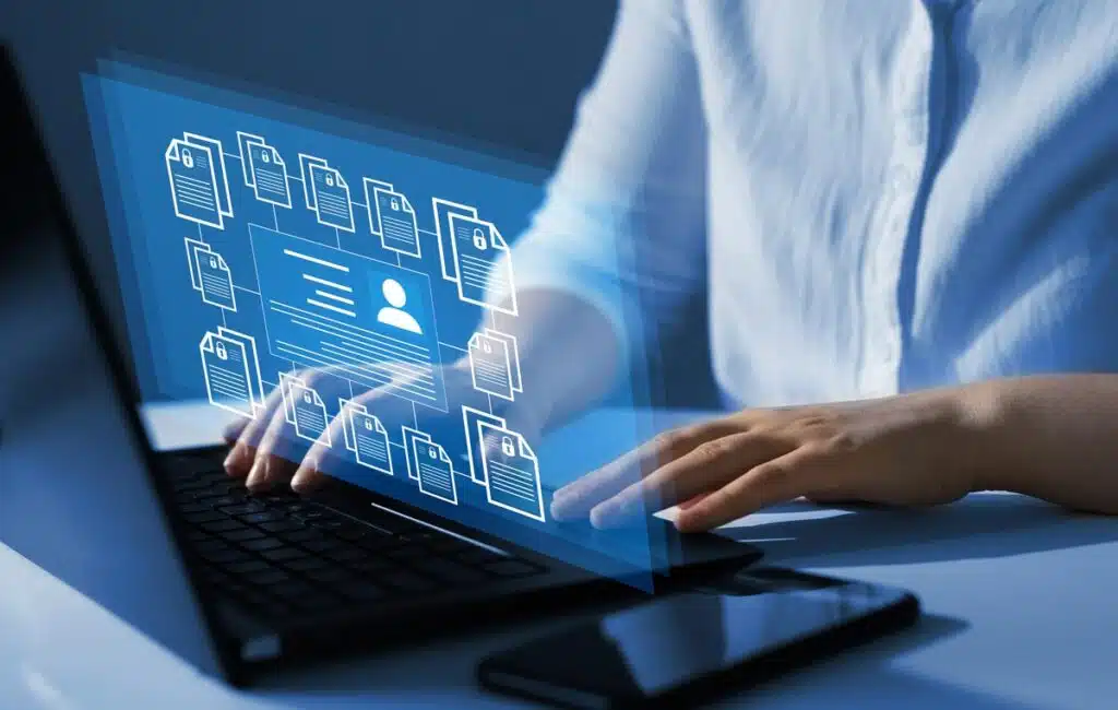 Close up of a womans hands using a laptop, representing the The Week subscription information privacy class action lawsuit settlement.