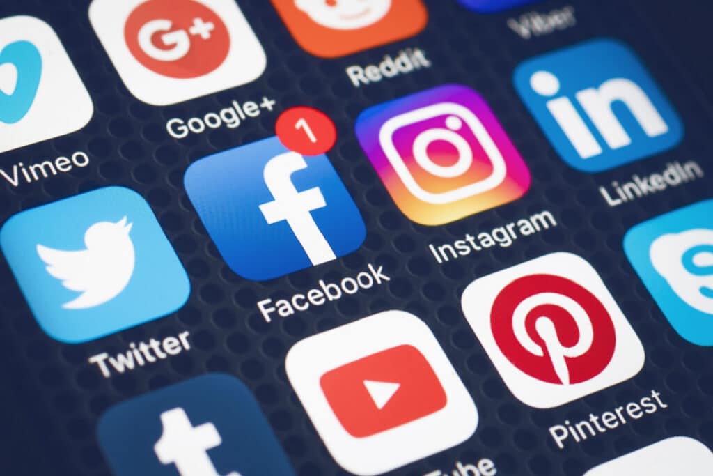 Various social media app icons on cell phone