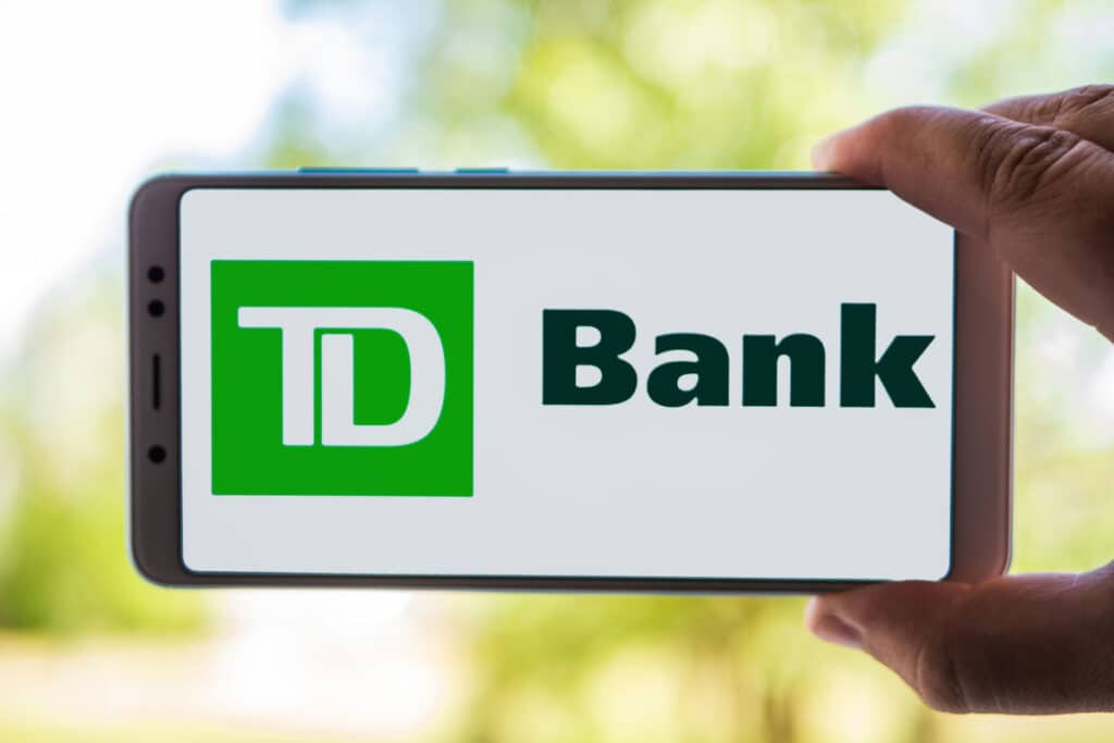 Person Holding Cellphone with TD Bank logo on screen