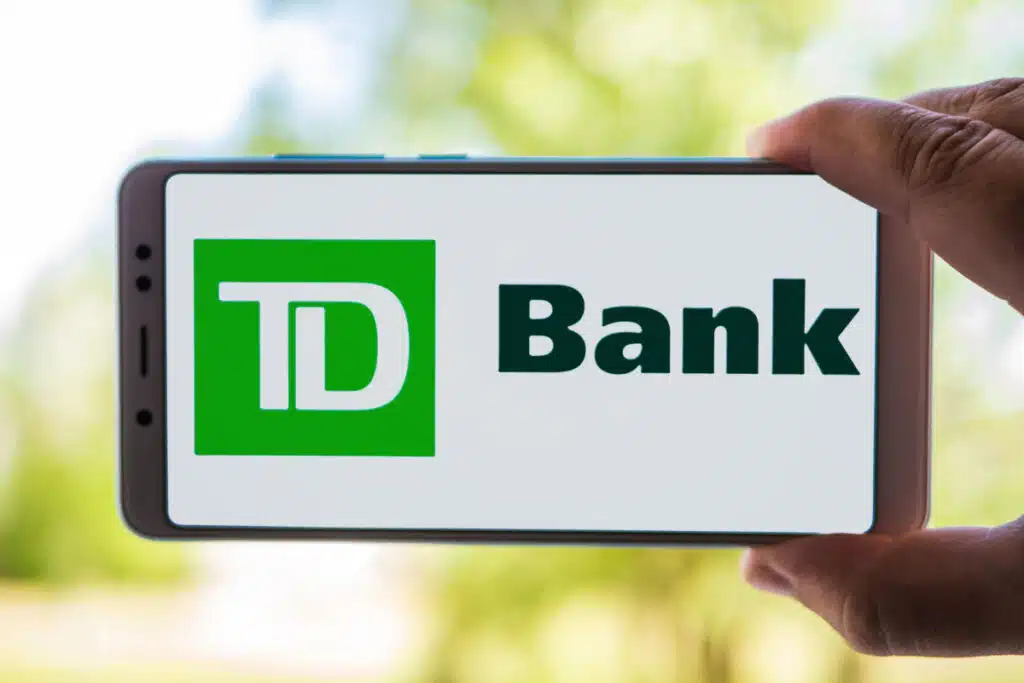 Person Holding Cellphone with TD Bank logo on screen
