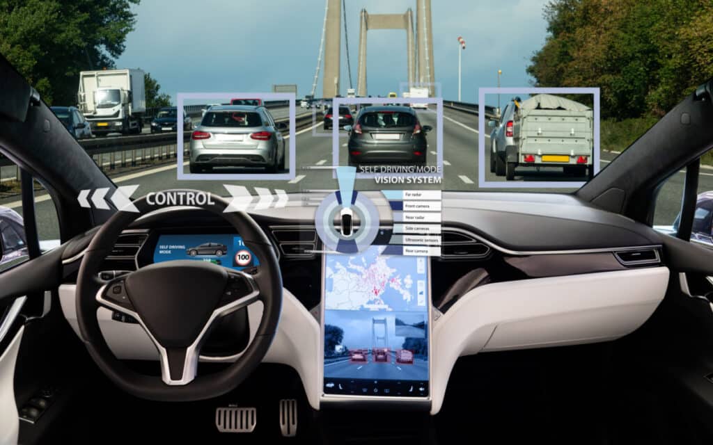 Inside of a Tesla displaying self driving feature