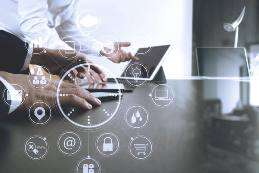 Businessman using mobile phone and digital tablet and laptop representing the Alacrity Solutions Group data breach class action lawsuit settlement.