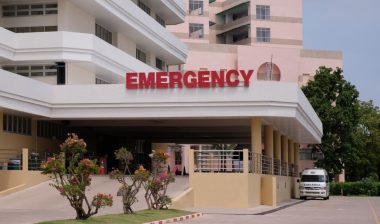 Main Entrance Of Modern Hospital Building With Signs representing the Baptist Emergency Hospital settlement.