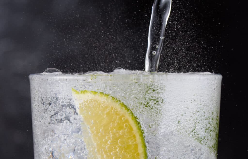 A fizzy drink being poured into a glass