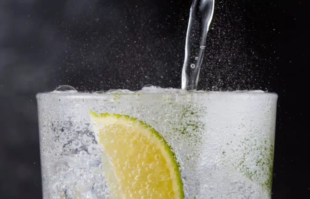 A fizzy drink being poured into a glass