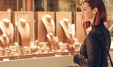 Pretty woman looking at jewelry in store window representing the Don Roberto Jewelers data breach settlement.