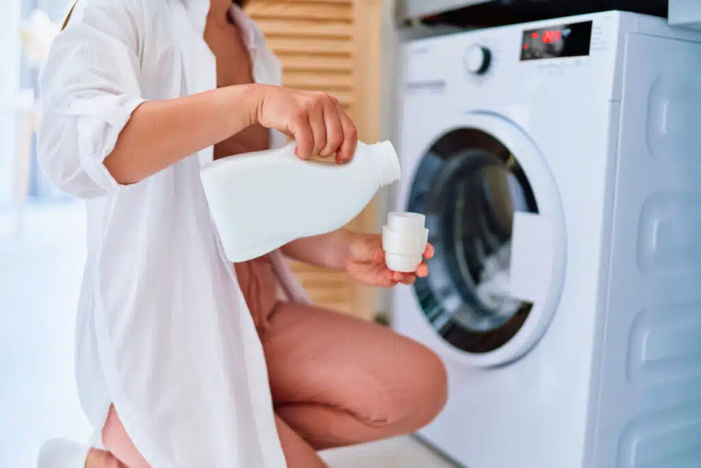 A woman bending down pouring