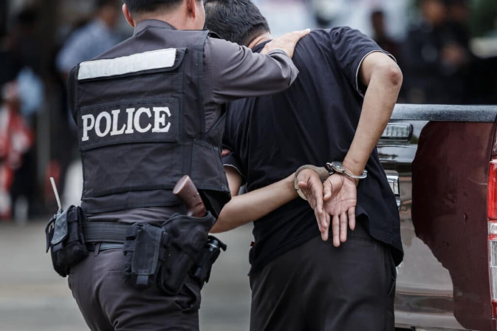 Police arresting a man representing the District of Columbia discriminatory arrests settlement.