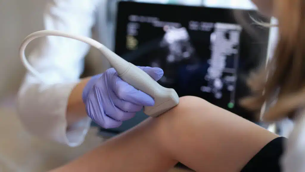 A doctor scanning a patient's knee, representing the Bone & Joint Clinic class action