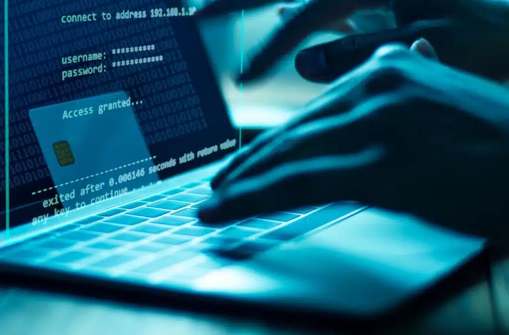 A person types a username and password on a laptop, representing the Oklahoma City University data breach class action.