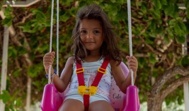 kid in outdoor swing
